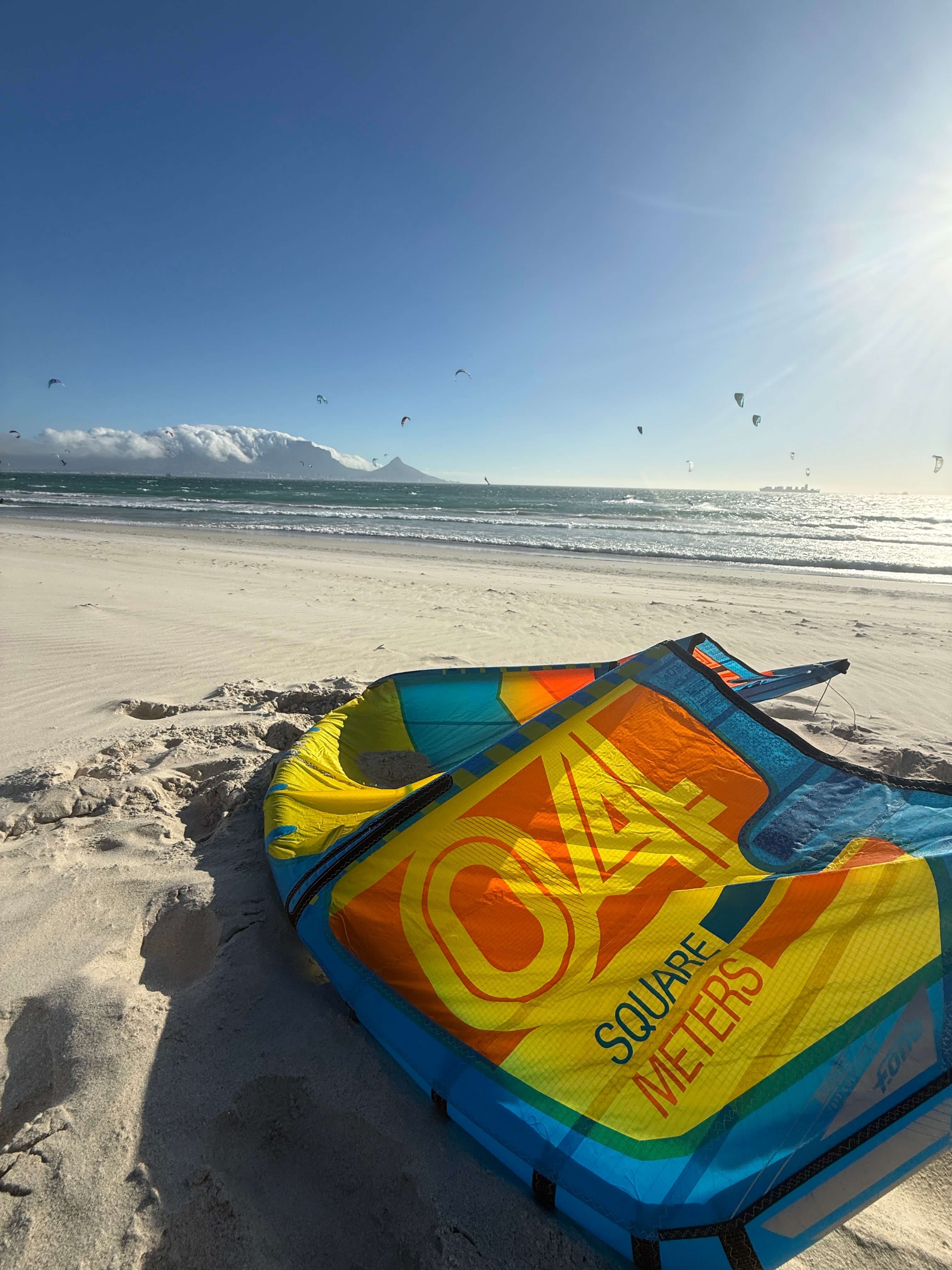 Kite on Blouberg beach with Table Mountain and kites in the sky