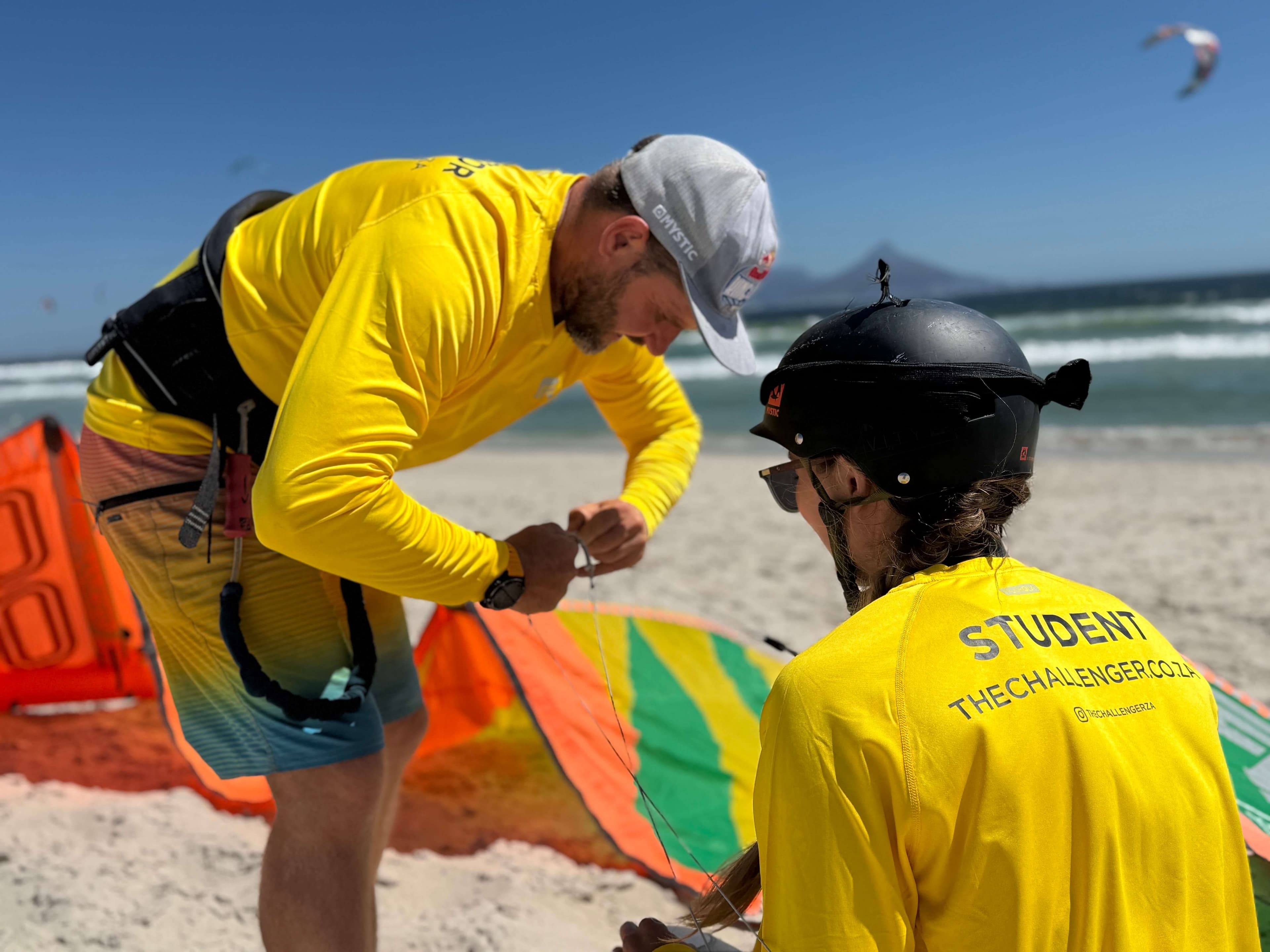 Instructor helping student with harness setup