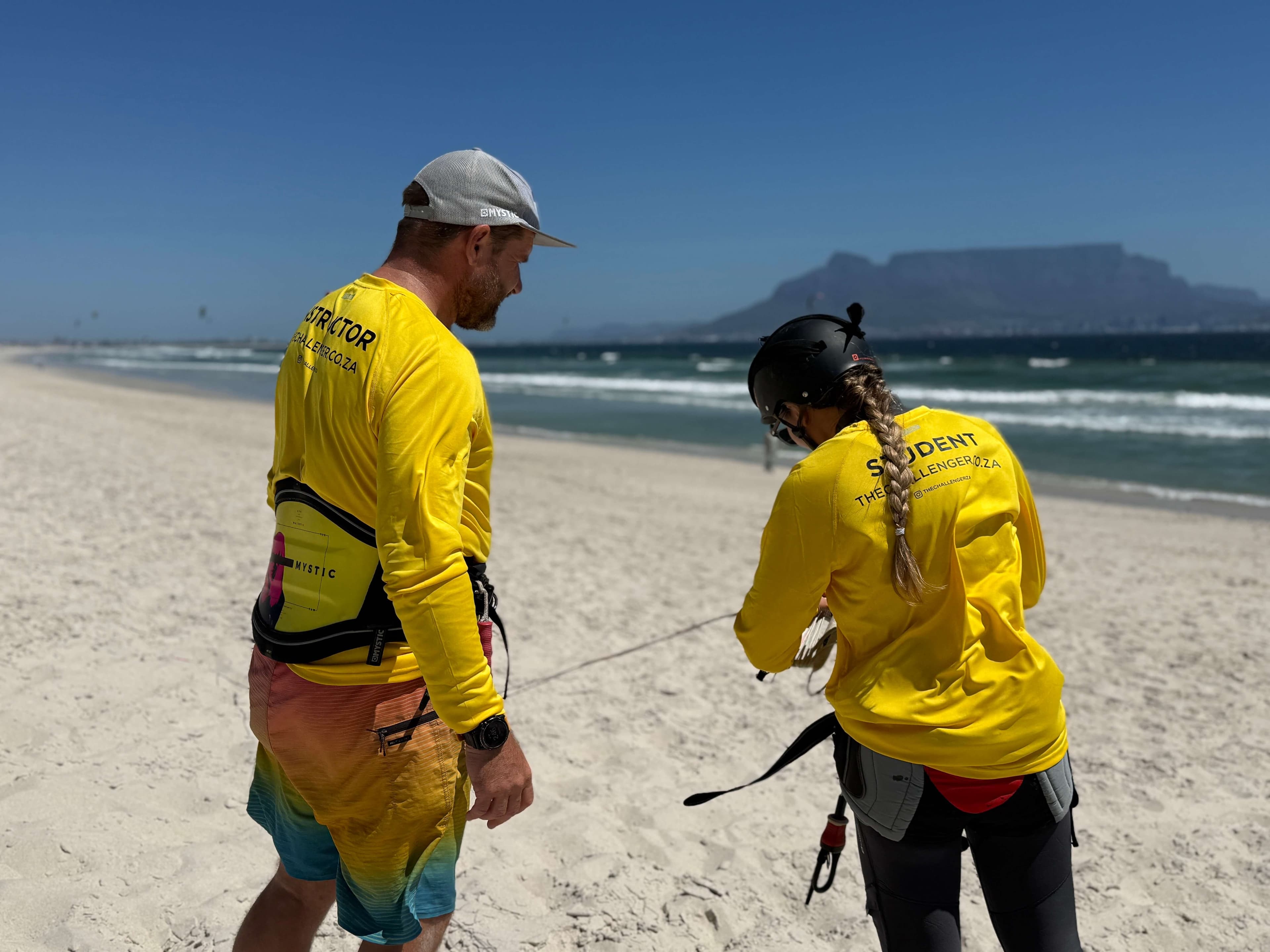 Instructor and student on Blouberg beach with Table Mountain