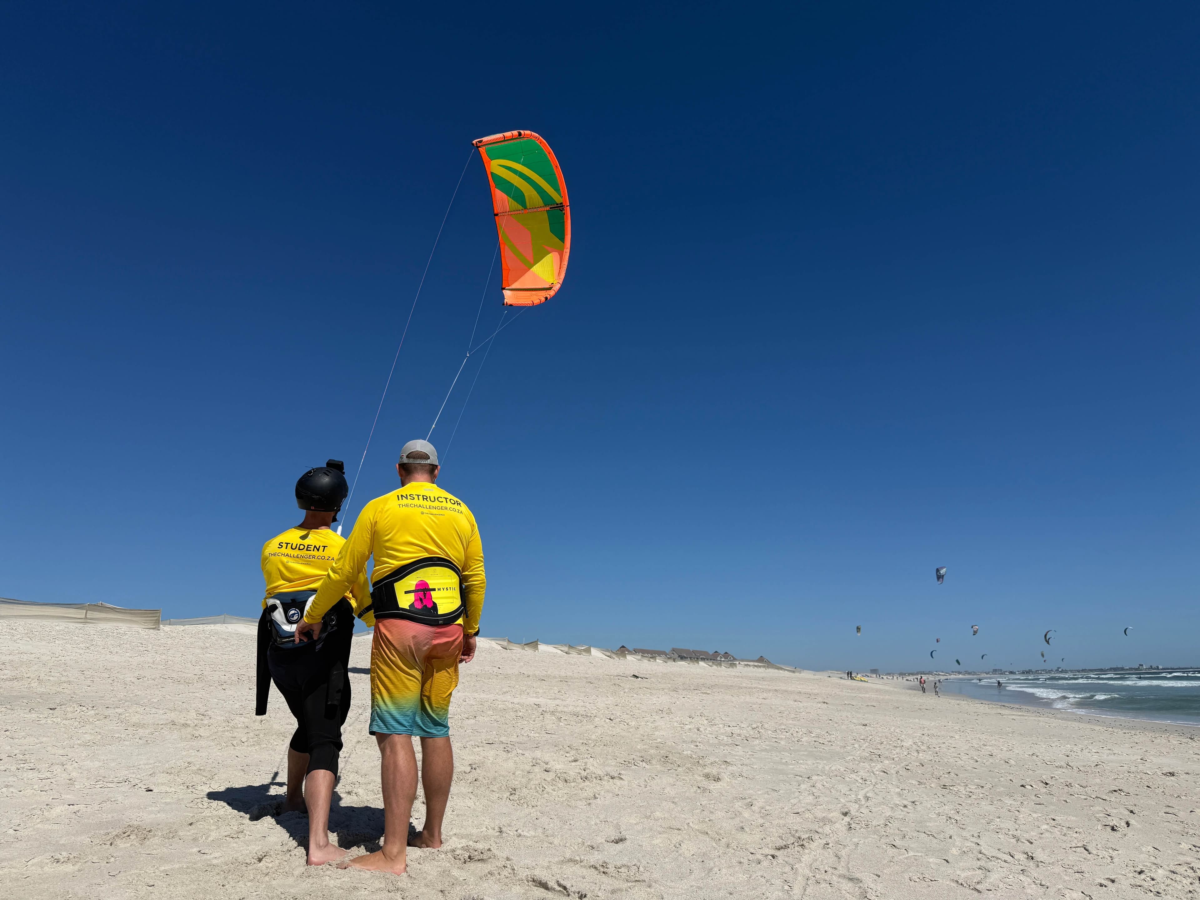 Student and instructor flying kite on Blouberg beach