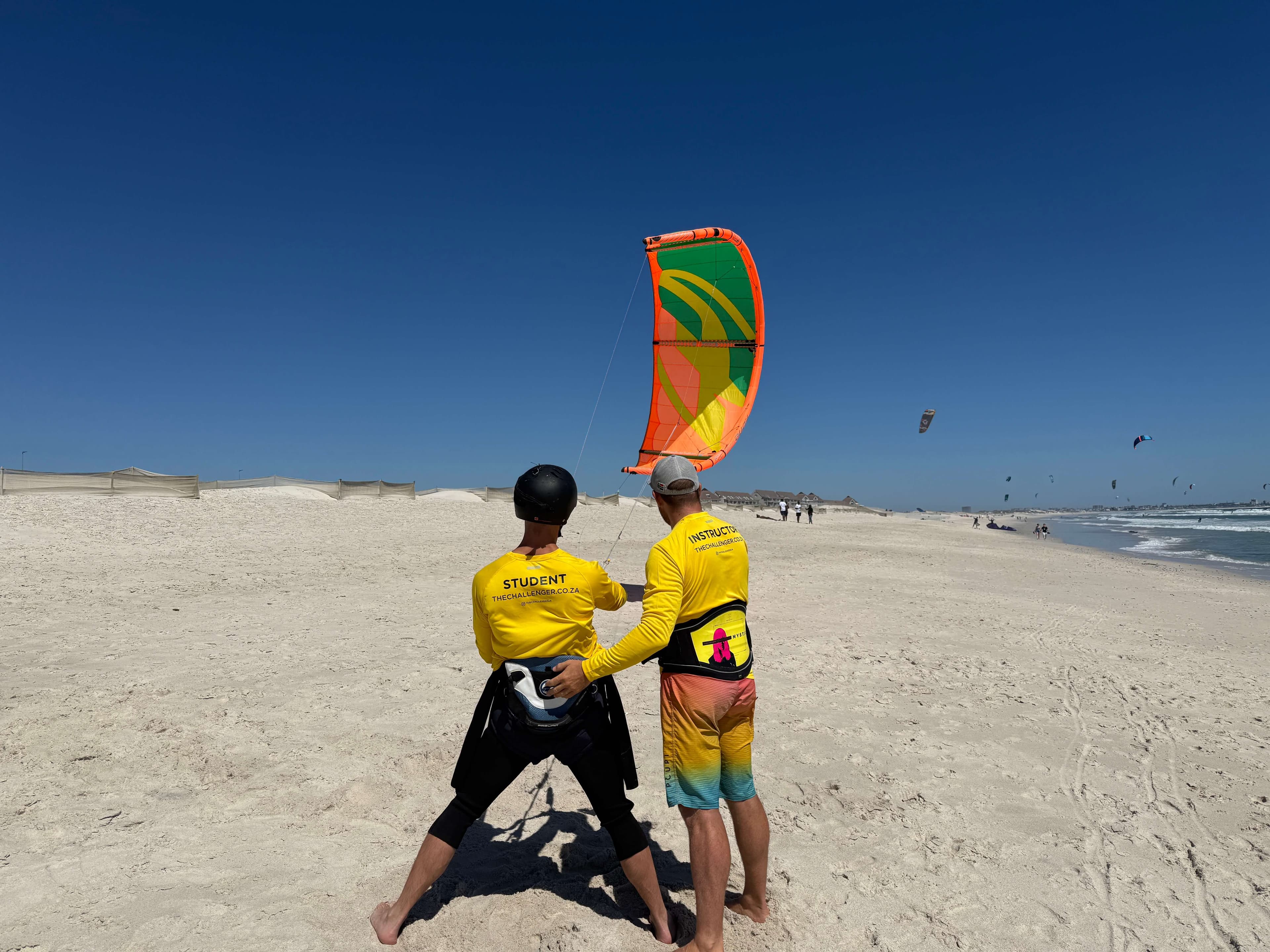 Student learning kite control on the beach